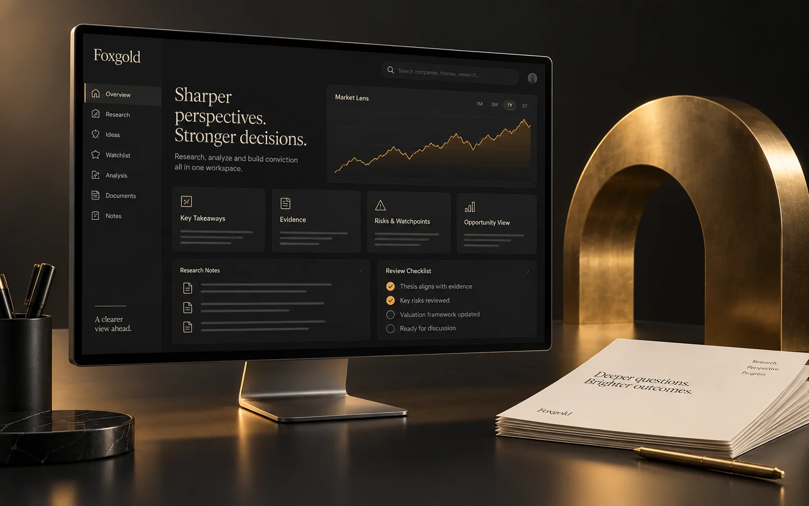 Investment research workspace in graphite and gold